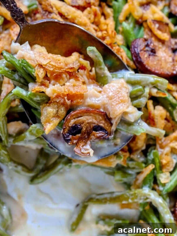 picture of spoon scooping green bean casserole from a baking dish