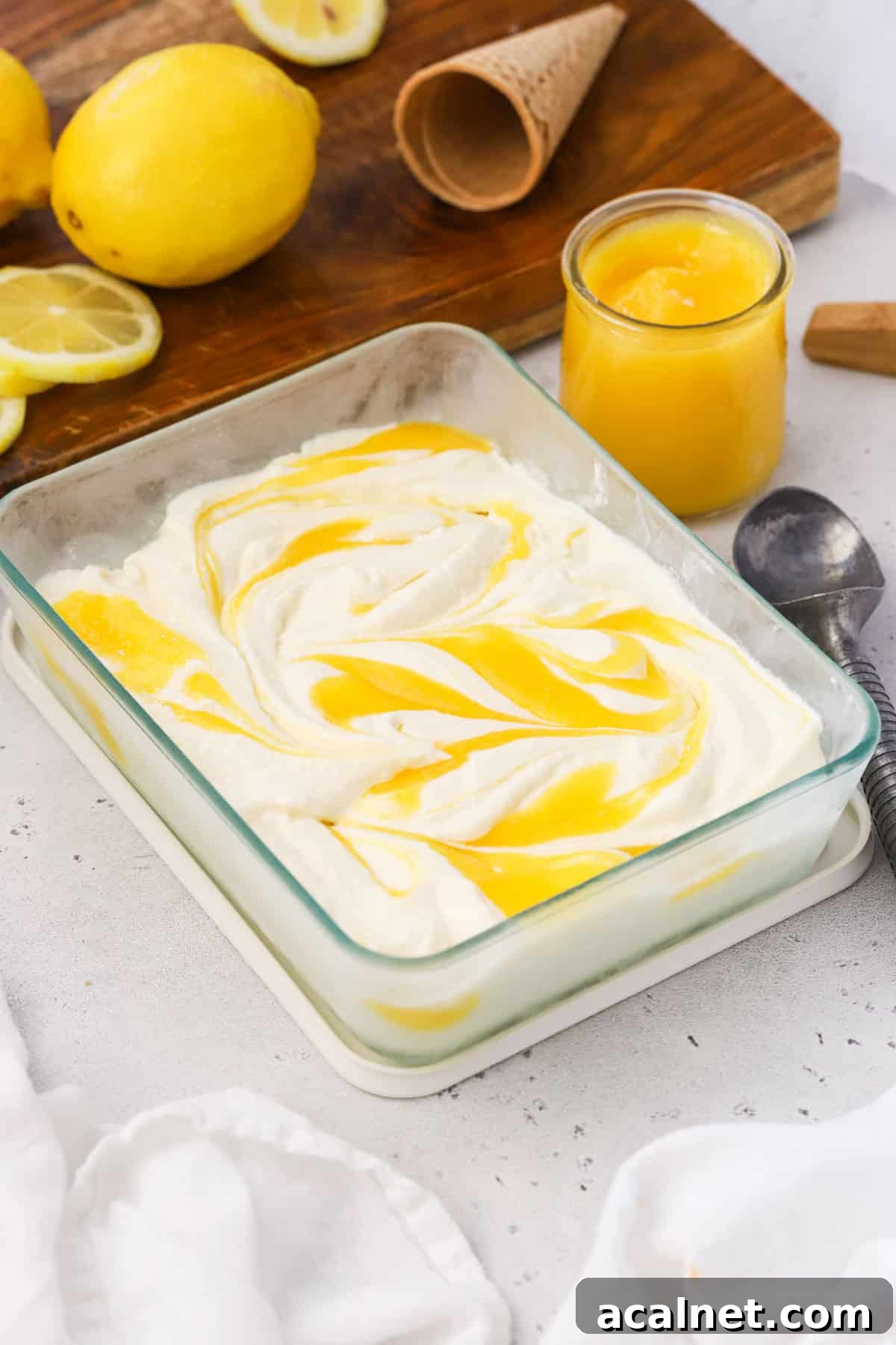 Lemon Ice Cream Swirled with Tangy Lemon Curd 8 a container of homemade lemon ice cream with lemon curd swirls