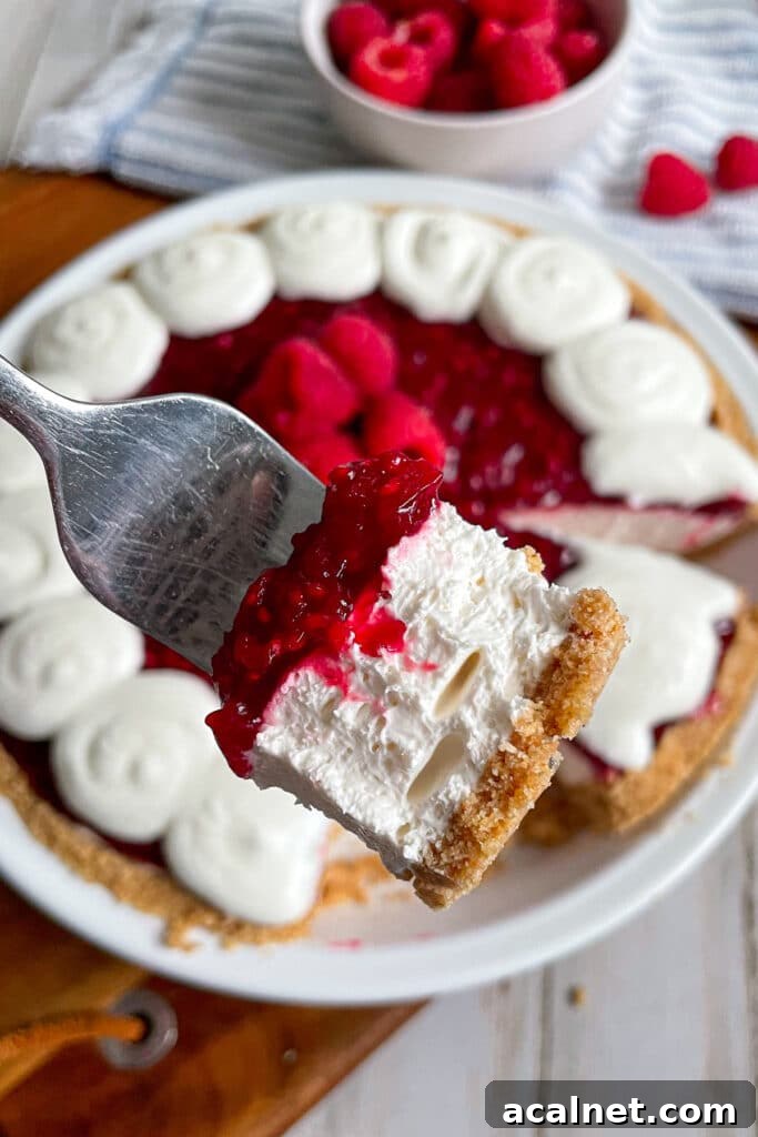 close up of raspberry cream pie on a fork