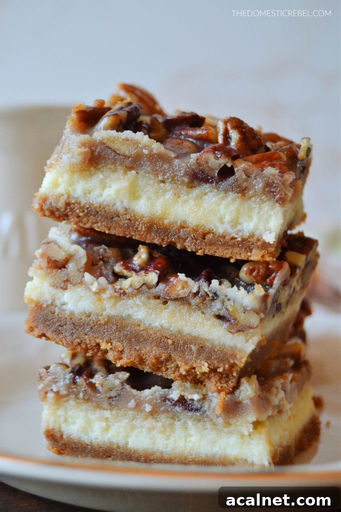 Pecan Pie Cheesecake Bars Recipe 4 a three-high stack of pecan pie cheesecake bars on a gold-rimmed plate.
