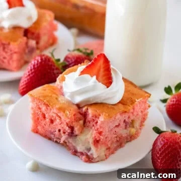 Slice of Strawberry Earthquake Cake on a plate with cheesecake swirl visible and fresh strawberries on top.