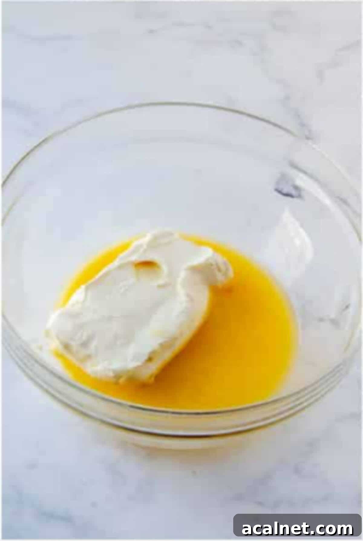 Melted butter and cream cheese in a bowl for the cheesecake layer.