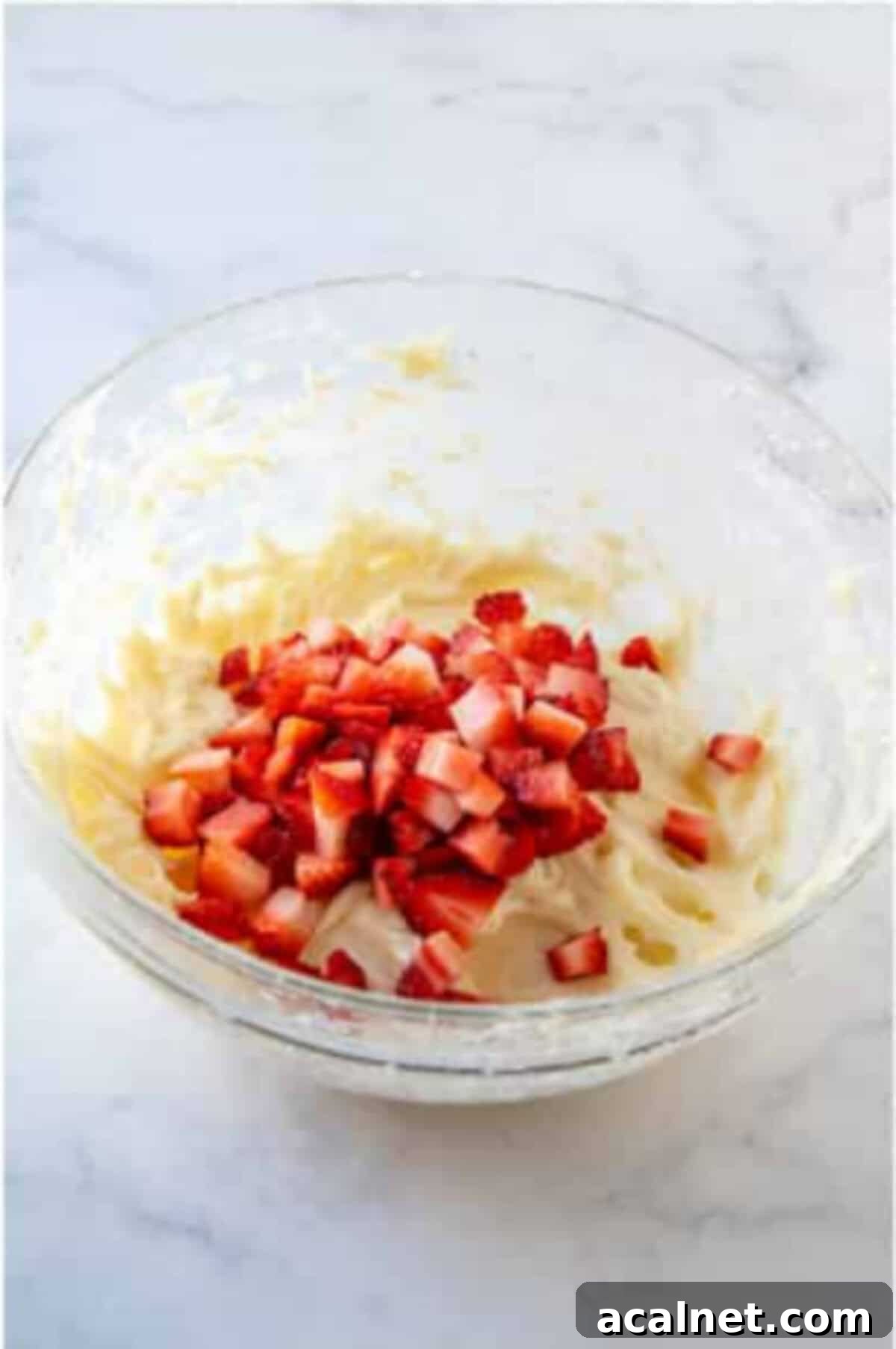 Fresh strawberries folded into the cheesecake mixture.