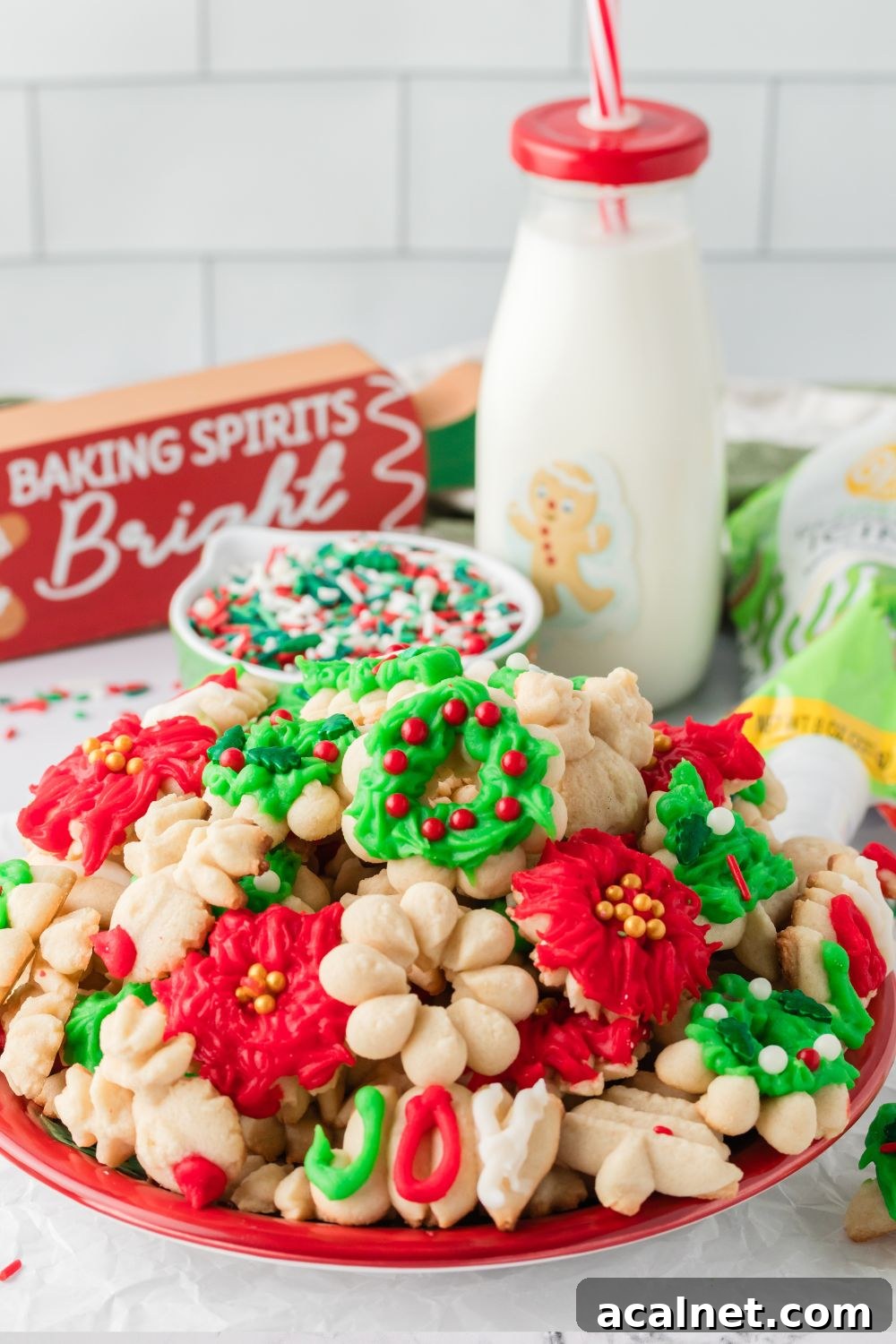 Classic Christmas Spritz Cookie Recipe 16 plate with cookies and tall glass of milk