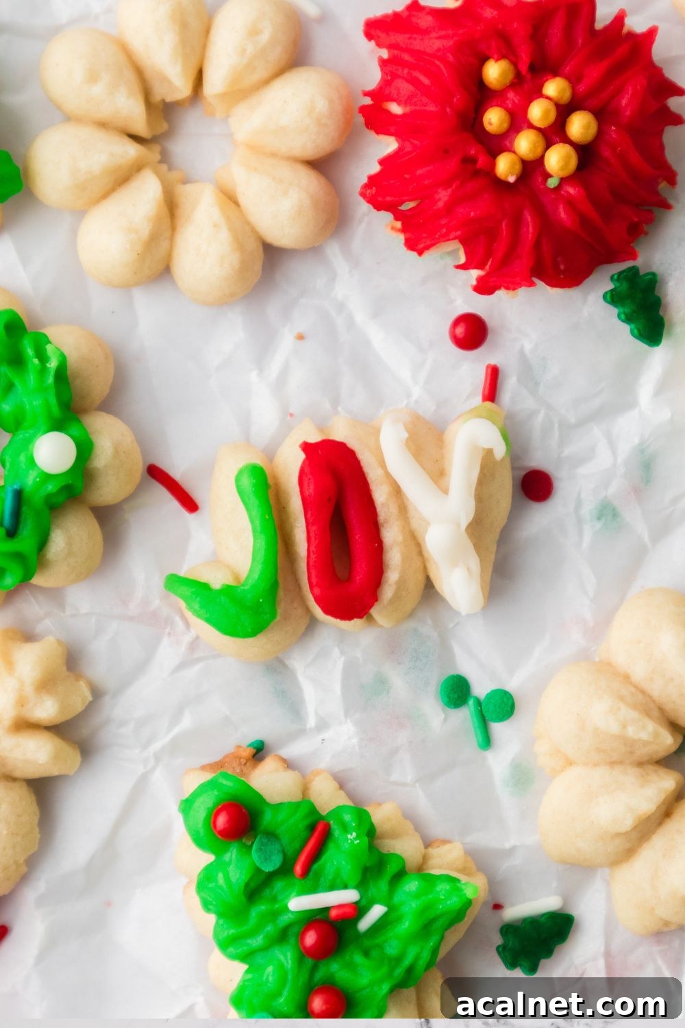Classic Christmas Spritz Cookie Recipe 17 joy worded cookie on table with more cookies around it