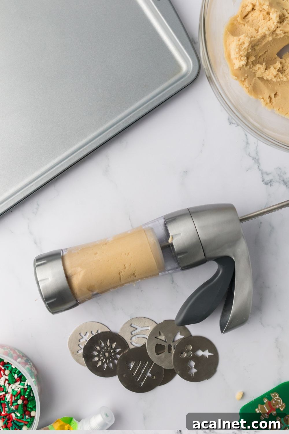 Classic Christmas Spritz Cookie Recipe 9 cookie press with cookie dough in it