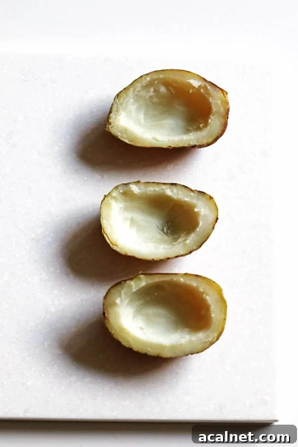 Potatoes cut in half and scooped out.
