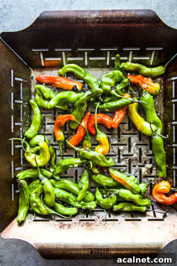 shishito peppers in a grilling basket