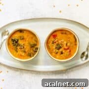 Two bowls of venison lentil stew on a serving tray.