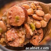 Crockpot beans on a wooden spoon.