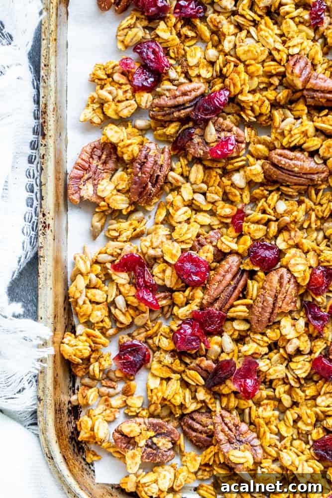 How to Make Pumpkin Spice Granola 27 Overhead shot of pumpkin spice granola on a tray with towel.