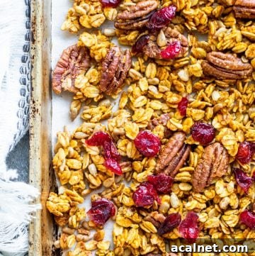 Overhead shot of pumpkin spice granola on a tray with towel.