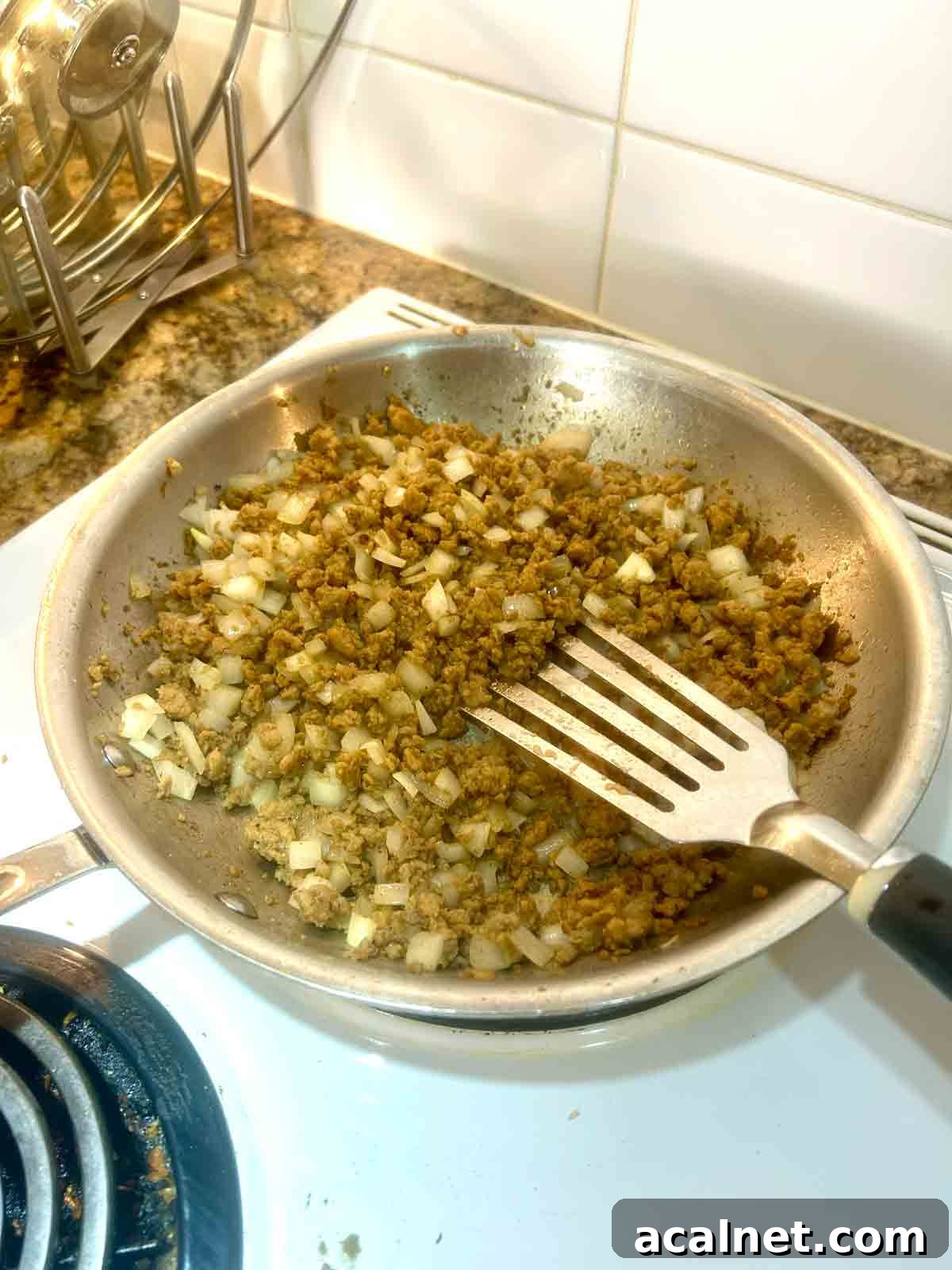Hearty Breakfast Casserole with Sausage and Cheese 5 ground sausage and onions being cooked in skillet.