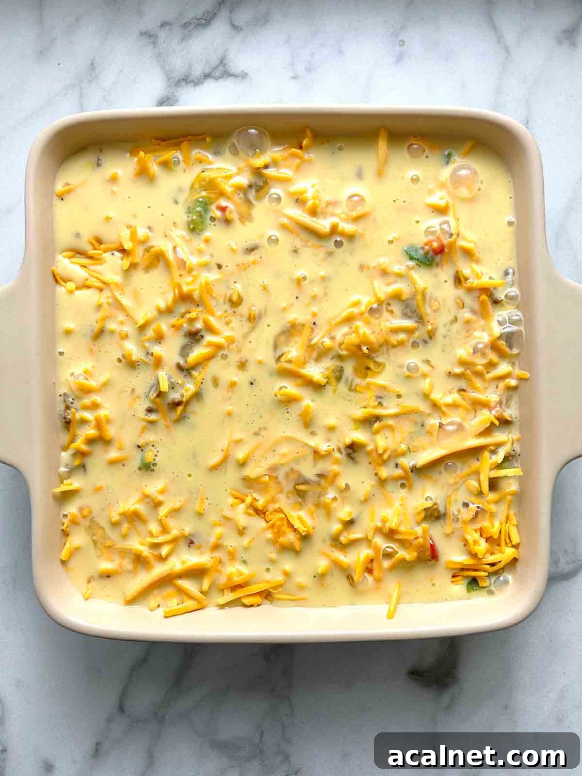 Hearty Breakfast Casserole with Sausage and Cheese 9 egg mixture pour over cheese in casserole dish.