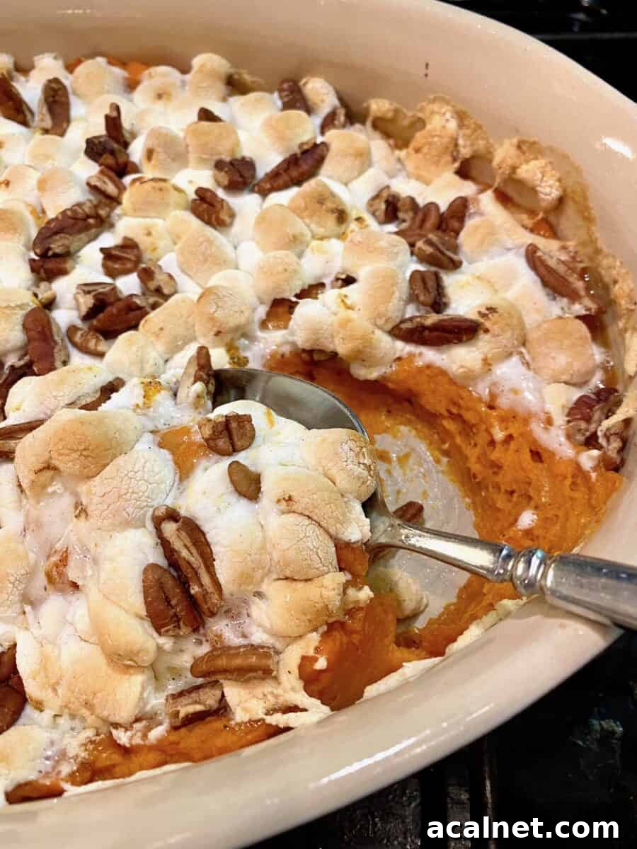 Sweet potato casserole in a baking dish with a spoon 