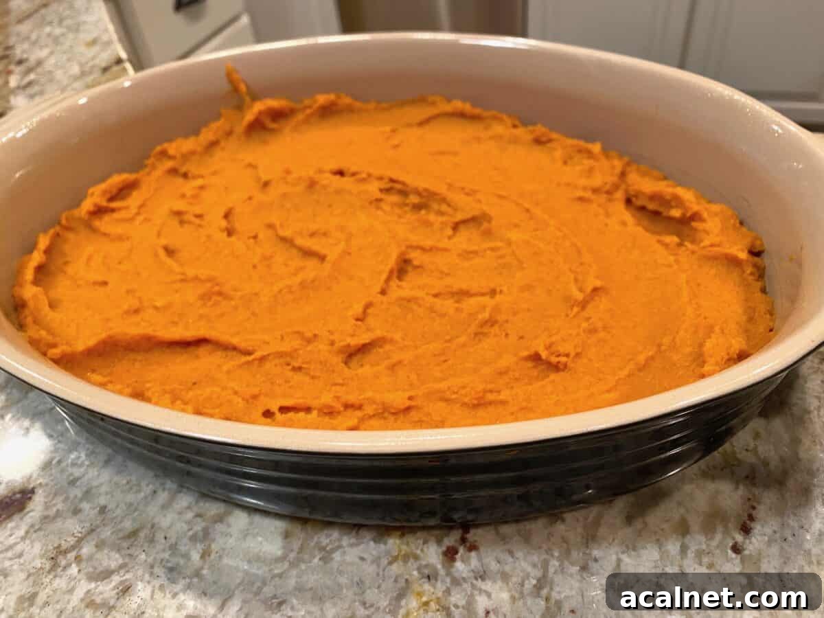 Mashed sweet potatoes in a layer in a baking dish