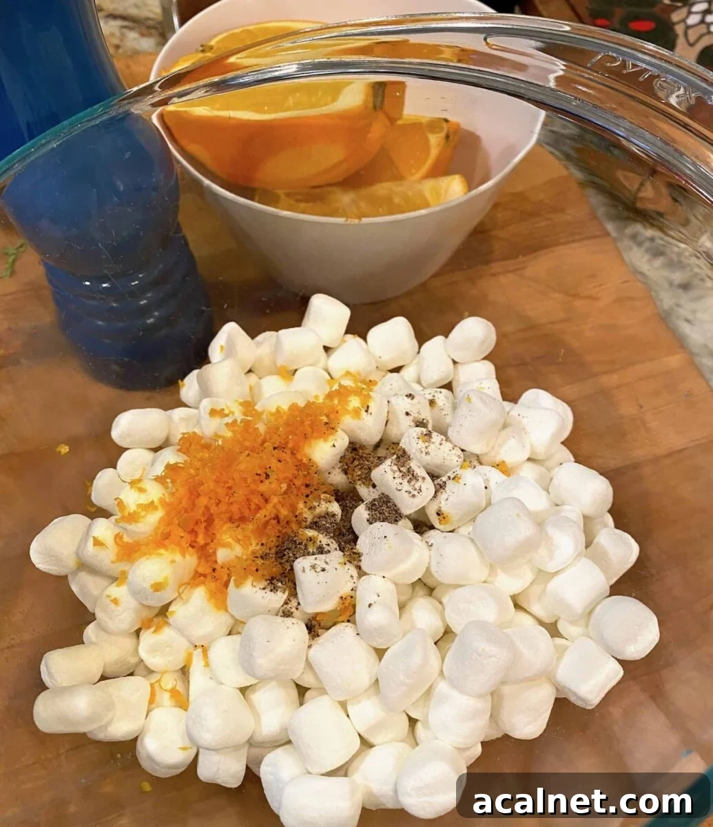 Mini marshmallows in a bowl with orange zest and pepper